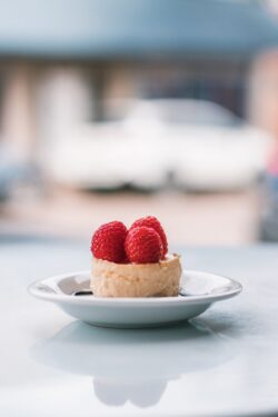 cheesecake raspberry dessert gourmet mini cake sweet pastry fine dining elegant berry white background minimal plating delicious