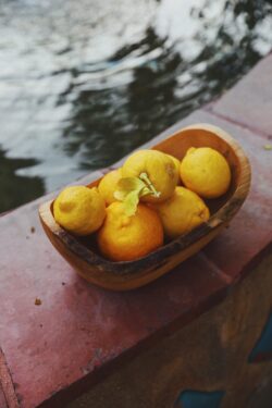 lemons fruit yellow citrus wooden bowl fresh organic summer mediterranean water reflection outdoor healthy eating rustic vibrant nature