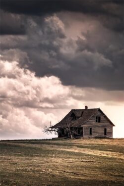 abandoned house farmhouse stormy clouds dramatic sky lonely building prairie field rustic vintage decay melancholy landscape cloudy moody scenery