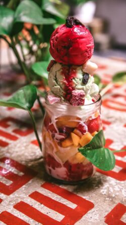 ice cream dessert sundae fruit parfait sweet treat food photography gourmet dessert healthy eating strawberry mango mint ice cream foodie glass jar dessert vibrant food styling