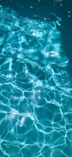 sparkling water swimming pool water ripples sun glare turquoise blue light reflections clear water liquid surface sunlit waves aqua blue refreshing summer vibe water texture bright surface calm wa