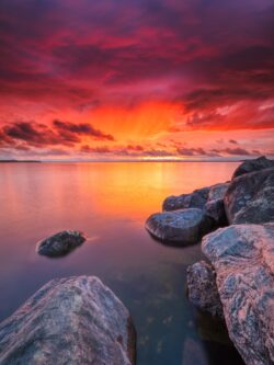 sunset sunrise clouds red sky ocean rocks horizon dramatic nature beach dusk vibrant reflection calm
