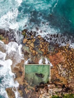 aerial ocean coast rock pool waves swimming nature turquoise beach cliff drone view water shore cliffs