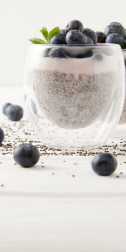 chia pudding breakfast healthy food blueberries yogurt glass white background clean eating aesthetic morning meal fitness diet superfood