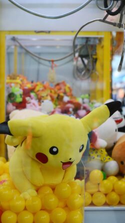 pikachu plush claw machine pokemon arcade game nintendo pocket monsters japanese culture toy vending machine yellow aesthetic kawaii gaming center plushies prize game childhood nostalgia