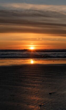 sunset beach ocean sea horizon golden hour waves shore sand reflection nature calm tranquil coastal scenery
