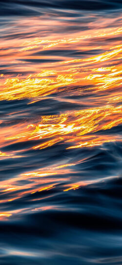 water waves ocean abstract sunset reflection golden hour blue orange liquid texture surface ripples sea movement