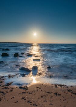 sunset ocean beach coast sunrise golden hour water stones horizon peaceful serene nature summer seascape meditation
