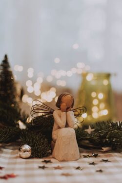 christmas angel figurine willowtree bokeh lights fir pine decorations holiday winter festive spirit closeupshot indoor