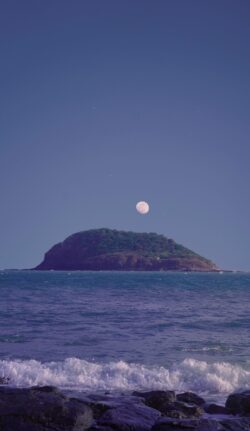 full moon island ocean sea night sky rocks waves blue calm tranquil nature scenery astronomy horizon