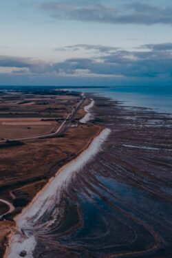 aerial coast shore ocean road fields horizon blue nature calm scenic earth view landscape minimal travel