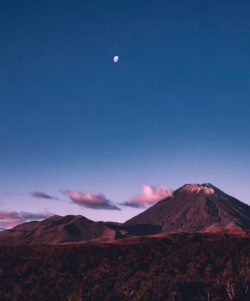 mountain peak volcano moonlight dusk twilight purple sky clouds snow cap nature wilderness highland scenic summit night sky minimalist