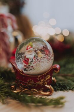 snow globe santa sleigh christmas decor holiday fir needles winter festive red gold minimal bokeh macro ornament