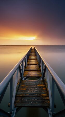 wooden pier dock bridge sunset horizon symmetry perspective calm water golden hour peaceful minimalist nature outdoor meditation view