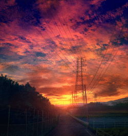 sunset electrical tower power lines evening sky orange clouds rural road scenic golden hour landscape cinematic peaceful nature horizon vibrant colors