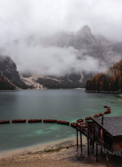 lake mountains fog mist boats braies italy reflection dolomites nature alpine autumn scenic cabin water
