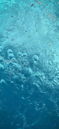 water bubbles underwater perspective clear blue water movement effervescence liquid texture light refraction surface agitation dynamic water abstract blue aquatic background bubbly deep blue vibran