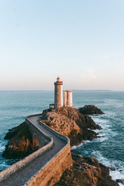 lighthouse ocean coast bridge architecture sea rocks france brittany maritime travel destination sunset coastal scenery navigation