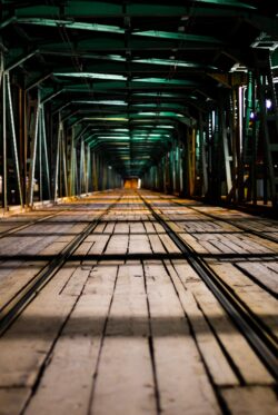 industrial bridge tunnel symmetry metal structure night urban architecture lines perspective green dark geometry engineering construction